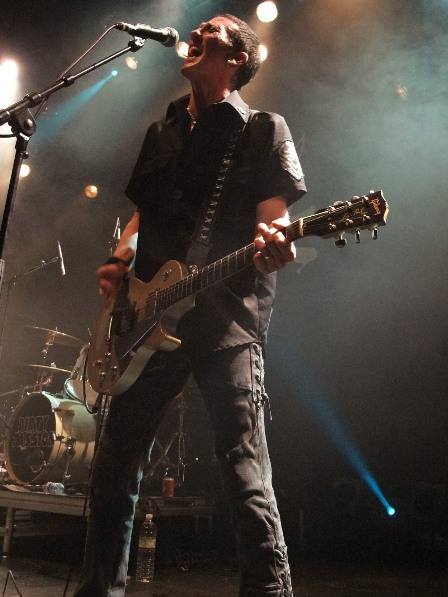 Xristian Simon playing guitar with Faster Pussycat