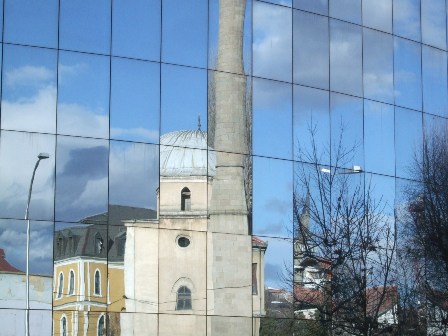 The Carshi Mosque and the Kosovo Museum reflected on a modern building