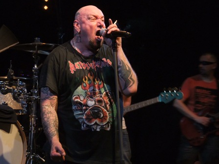 Paul DiAnno smoking a cigarette on stage