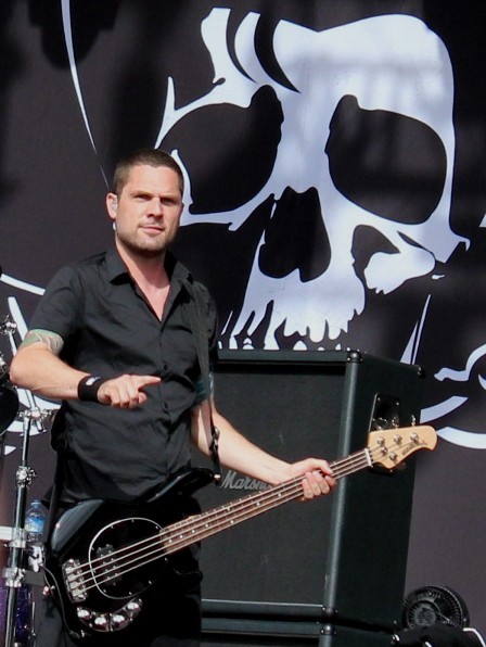 Anders Kjølholm playing bass with Volbeat